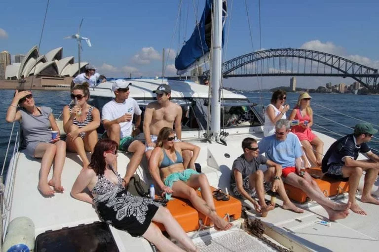 sydney catamaran cruises boys and girls sitting in top of boat