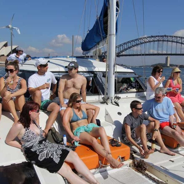 sydney catamaran cruises boys and girls sitting in top of boat 598x598